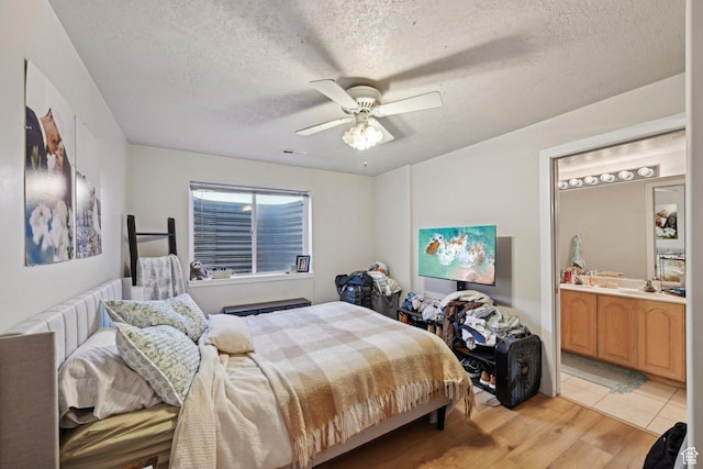 13994 S New Saddle Rd, Draper, UT 84020 - bedroom with a textured ceiling, light wood finished floors, a ceiling fan, and ensuite bath