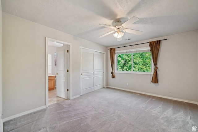 13994 S New Saddle Rd, Draper, UT 84020 - unfurnished bedroom featuring light colored carpet, baseboards, ensuite bathroom, a closet, and a textured ceiling