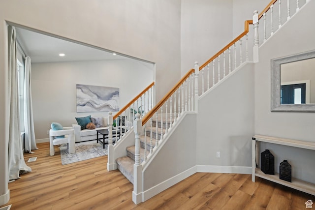 13994 S New Saddle Rd, Draper, UT 84020 - stairs with wood finished floors, a high ceiling, baseboards, and recessed lighting