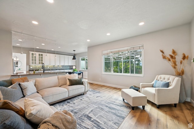 13994 S New Saddle Rd, Draper, UT 84020 - living room featuring recessed lighting, light wood-style flooring, and baseboards