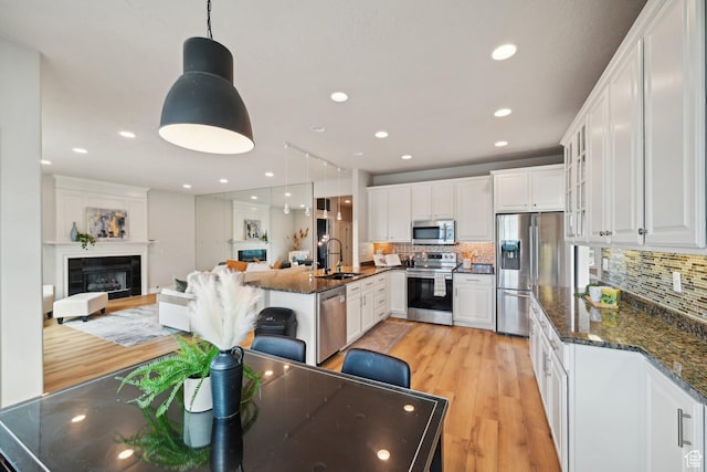 13994 S New Saddle Rd, Draper, UT 84020 - kitchen featuring stainless steel appliances, a sink, white cabinetry, light wood finished floors, and recessed lighting