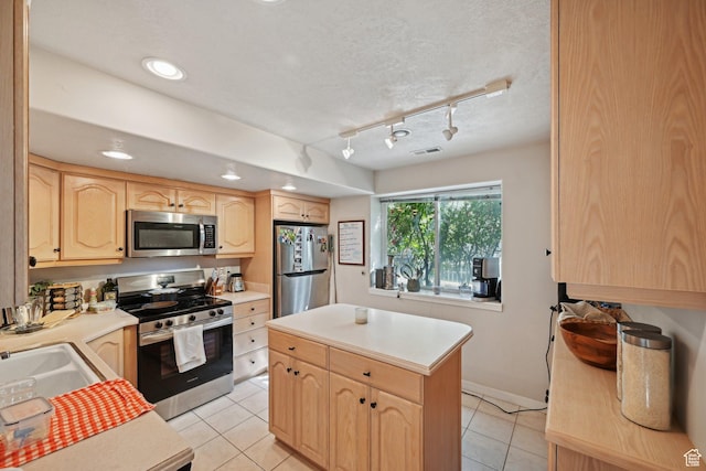 13994 S New Saddle Rd, Draper, UT 84020 - kitchen featuring stainless steel appliances, light brown cabinetry, light countertops, light tile patterned floors, and a center island