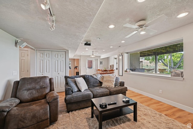 13994 S New Saddle Rd, Draper, UT 84020 - living room with a textured ceiling, wood finished floors, baseboards, a ceiling fan, and recessed lighting