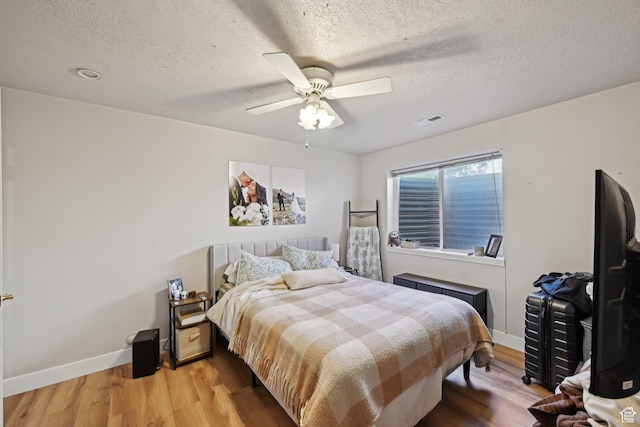 13994 S New Saddle Rd, Draper, UT 84020 - bedroom with wood finished floors, baseboards, a textured ceiling, and a ceiling fan