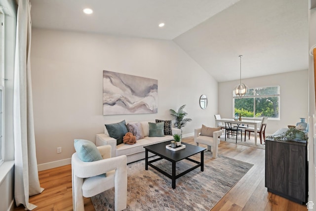13994 S New Saddle Rd, Draper, UT 84020 - living area featuring light wood finished floors, vaulted ceiling, baseboards, recessed lighting, and a chandelier