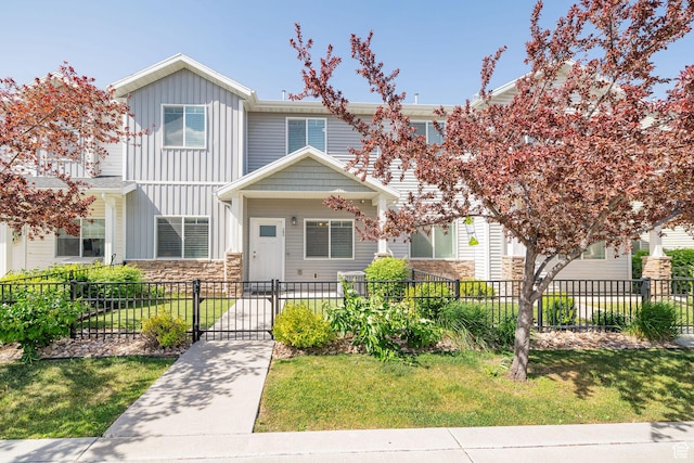 466 W 1595 N Unit 45-103, Logan, UT 84341 - view of front facade with board and batten siding, stone siding, and a gate