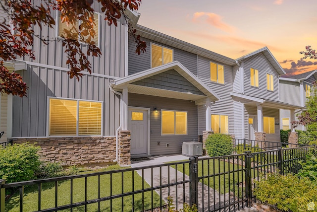 466 W 1595 N Unit 45-103, Logan, UT 84341 - view of front of property featuring board and batten siding, stone siding, and central AC unit