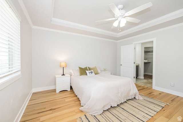 466 W 1595 N Unit 45-103, Logan, UT 84341 - bedroom featuring light wood-style flooring, ornamental molding, baseboards, and a tray ceiling