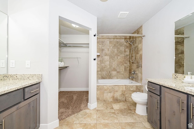 466 W 1595 N Unit 45-103, Logan, UT 84341 - bathroom with vanity, baseboards, toilet, a walk in closet, and tiled shower / bath combo