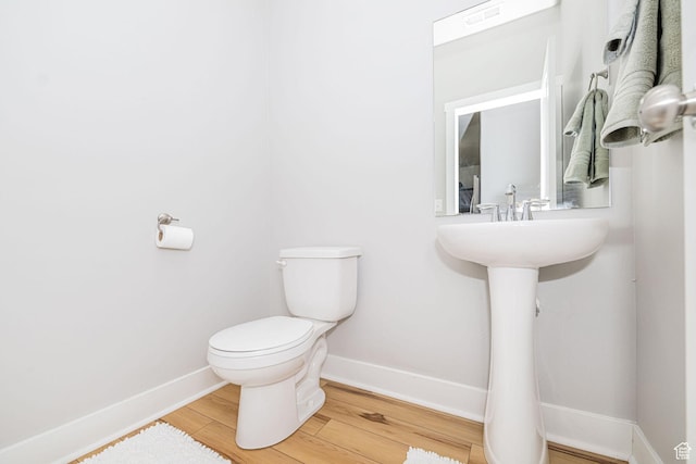 466 W 1595 N Unit 45-103, Logan, UT 84341 - half bathroom with baseboards, toilet, and wood finished floors