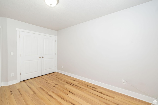 466 W 1595 N Unit 45-103, Logan, UT 84341 - unfurnished bedroom with light wood-style flooring, baseboards, and a closet