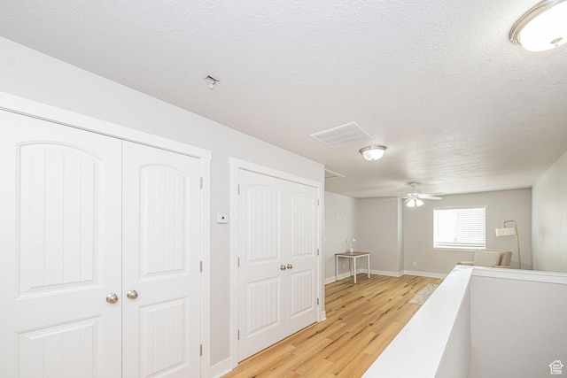466 W 1595 N Unit 45-103, Logan, UT 84341 - hall featuring light wood-style floors, baseboards, and a textured ceiling