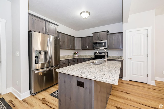 466 W 1595 N Unit 45-103, Logan, UT 84341 - kitchen with stainless steel appliances, light wood finished floors, dark brown cabinets, and baseboards
