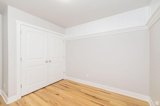 466 W 1595 N Unit 45-103, Logan, UT 84341 - unfurnished bedroom featuring baseboards, light wood finished floors, and a closet