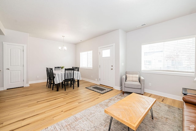 466 W 1595 N Unit 45-103, Logan, UT 84341 - living area with a chandelier, light wood-type flooring, and baseboards