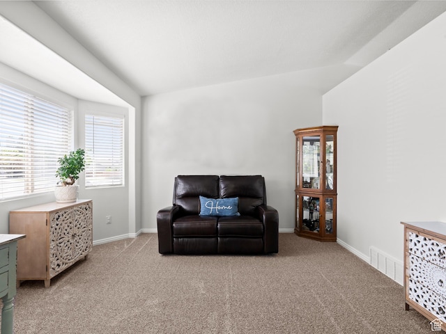sitting room featuring light carpet and baseboards