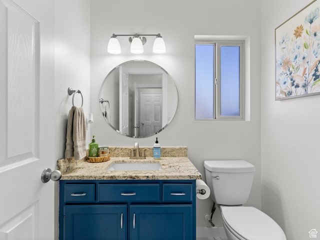 bathroom featuring toilet and vanity