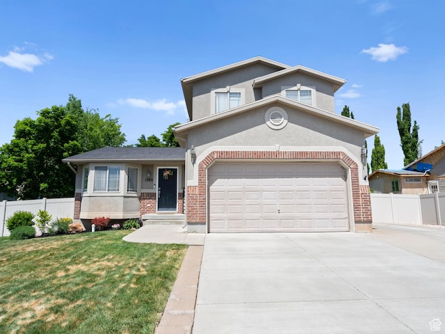 view of front of property with driveway, brick siding, and stucco siding