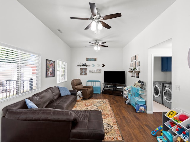 living room featuring washer and dryer, a ceiling fan, and dark wood finished floors