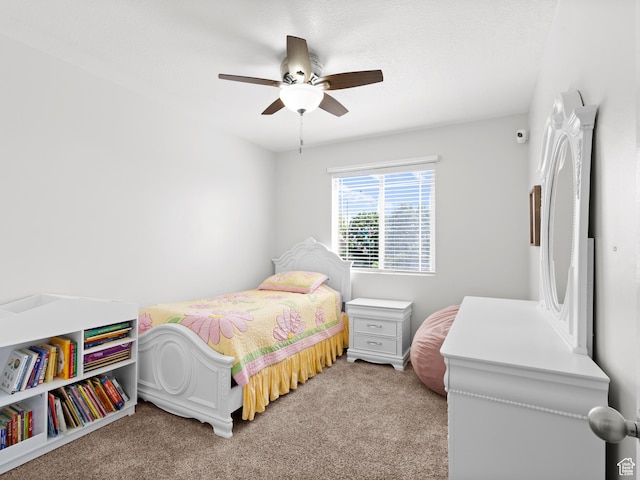 bedroom featuring light carpet and a ceiling fan