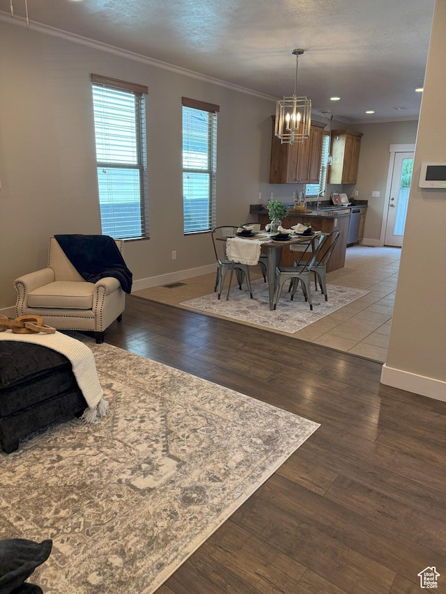 10342 S Millerton Dr, South Jordan, UT 84009 - dining space featuring a chandelier, baseboards, light wood-style floors, crown molding, and recessed lighting