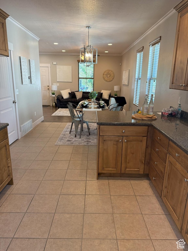 10342 S Millerton Dr, South Jordan, UT 84009 - kitchen featuring open floor plan, a peninsula, crown molding, light tile patterned flooring, and a chandelier