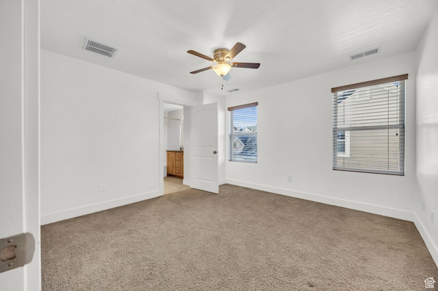 10342 S Millerton Dr, South Jordan, UT 84009 - unfurnished bedroom featuring baseboards, light colored carpet, a ceiling fan, and ensuite bathroom