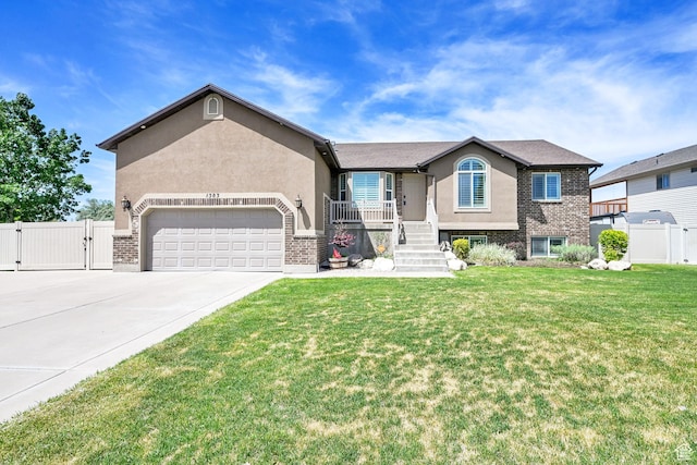 1383 N 4350 W, West Point, UT 84015 - ranch-style home with a gate, stucco siding, an attached garage, concrete driveway, and brick siding