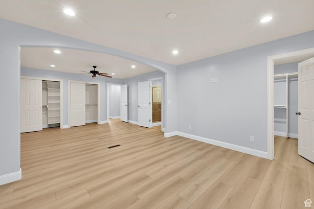 1383 N 4350 W, West Point, UT 84015 - unfurnished bedroom with baseboards, light wood-style flooring, recessed lighting, arched walkways, and multiple closets