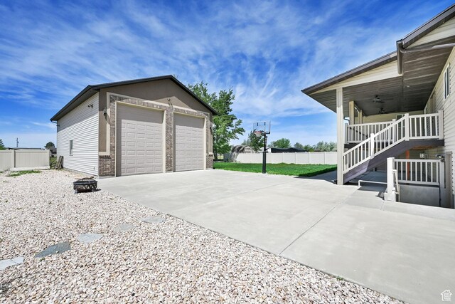 1383 N 4350 W, West Point, UT 84015 - view of home's exterior featuring a detached garage, a ceiling fan, fence, stairway, and an outbuilding