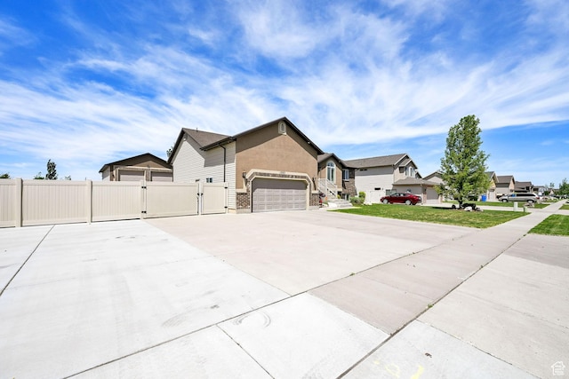 1383 N 4350 W, West Point, UT 84015 - view of front facade featuring a gate, fence, a residential view, a garage, and concrete driveway