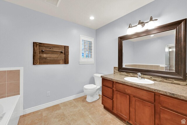 1383 N 4350 W, West Point, UT 84015 - bathroom featuring toilet, a garden tub, baseboards, vanity, and tile patterned floors