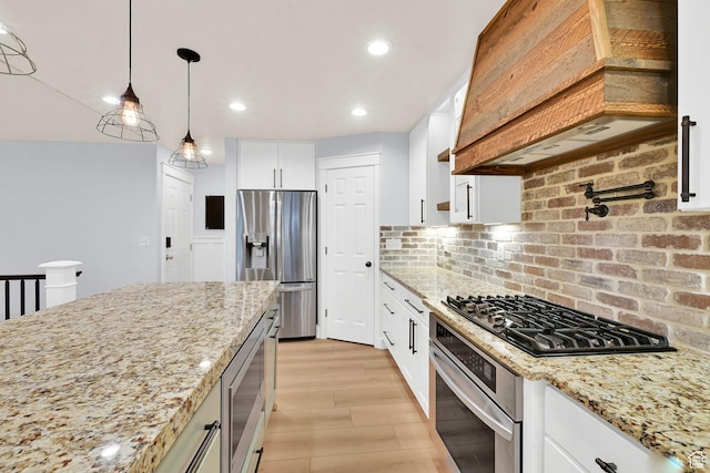 1383 N 4350 W, West Point, UT 84015 - kitchen featuring stainless steel appliances, custom range hood, light stone counters, tasteful backsplash, and decorative light fixtures