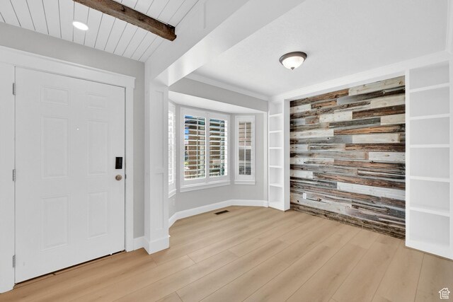 1383 N 4350 W, West Point, UT 84015 - foyer featuring wooden walls, an accent wall, light wood-style flooring, baseboards, and beamed ceiling