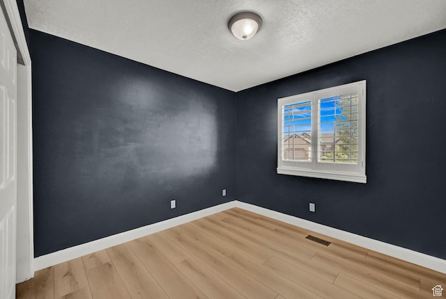 1383 N 4350 W, West Point, UT 84015 - empty room featuring a textured ceiling, wood finished floors, and baseboards