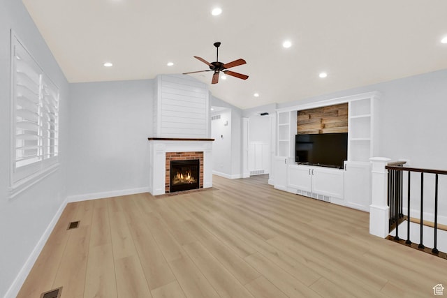 1383 N 4350 W, West Point, UT 84015 - unfurnished living room featuring ceiling fan, vaulted ceiling, light wood-style flooring, a brick fireplace, and baseboards
