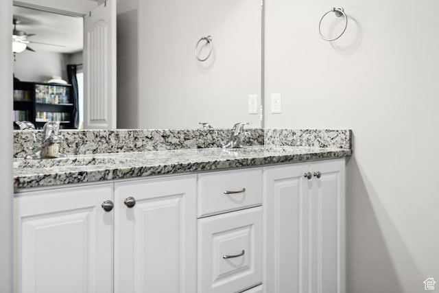 bathroom with a ceiling fan and vanity