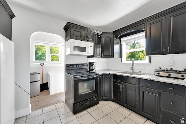 815 E 22nd St, Ogden, UT 84401 - kitchen featuring white appliances, a sink, backsplash, light stone counters, and light colored carpet