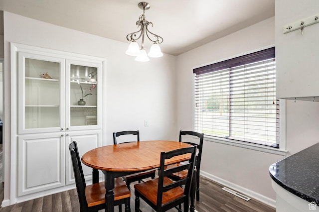 395 N 1st St, Tooele, UT 84074 - dining room featuring dark wood-style flooring, baseboards, and a chandelier