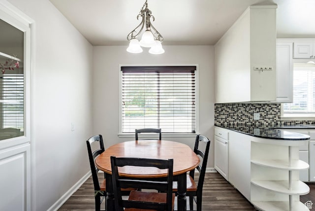 395 N 1st St, Tooele, UT 84074 - dining space featuring dark wood finished floors, a chandelier, and baseboards