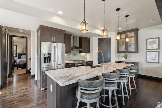 3029 Canyon Links Dr, Park City, UT 84098 - kitchen with premium appliances, a sink, wall chimney range hood, dark brown cabinets, and glass insert cabinets