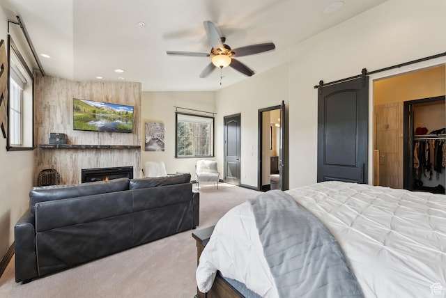 3029 Canyon Links Dr, Park City, UT 84098 - carpeted bedroom with a barn door, a large fireplace, recessed lighting, baseboards, and a ceiling fan