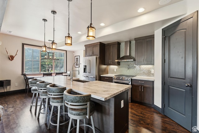 3029 Canyon Links Dr, Park City, UT 84098 - kitchen featuring high end appliances, wall chimney exhaust hood, a sink, dark wood-style floors, and recessed lighting