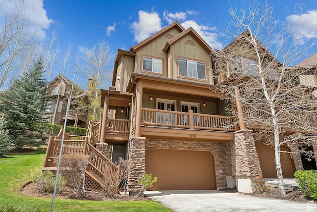 3029 Canyon Links Dr, Park City, UT 84098 - view of front of house featuring a garage, concrete driveway, stone siding, stairway, and board and batten siding