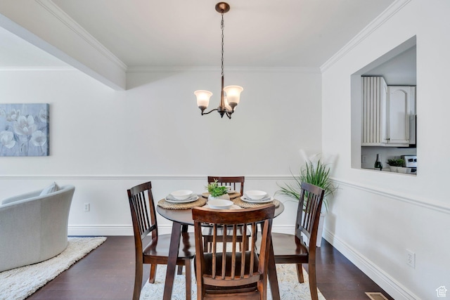 dining space with a chandelier, dark wood-style floors, crown molding, and baseboards