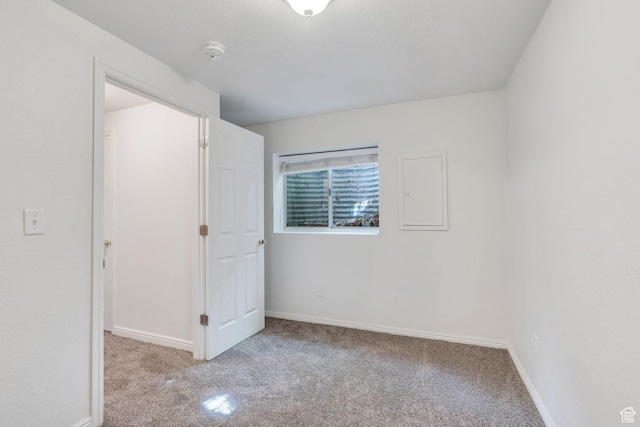 unfurnished bedroom with carpet floors and baseboards