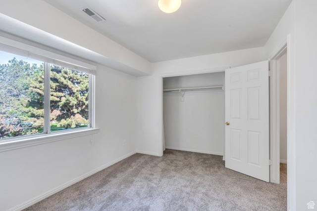 unfurnished bedroom featuring carpet flooring, a closet, and baseboards