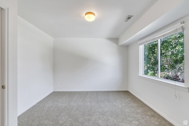 carpeted spare room with baseboards