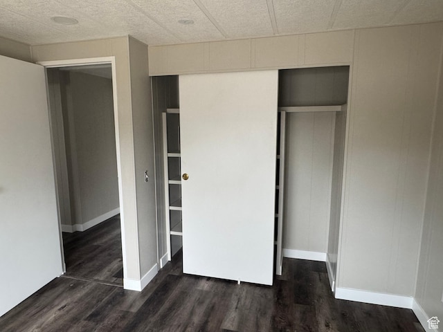 22 S 400 E, Myton, UT 84052 - unfurnished bedroom with a closet, dark wood-style floors, and baseboards