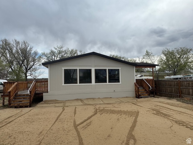 22 S 400 E, Myton, UT 84052 - rear view of house featuring a wooden deck and fence